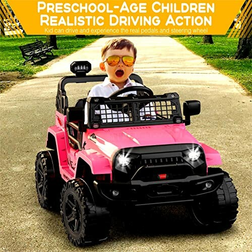 Child driving a pink toy car on a park path