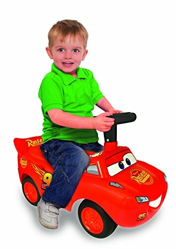 Child riding a Lightning McQueen toy car.
