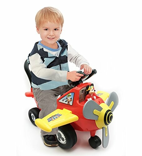 Child playing on a toy airplane ride-on