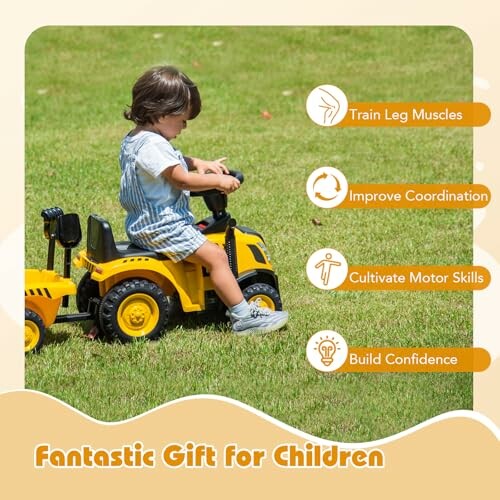 Child riding a yellow toy tractor on grass