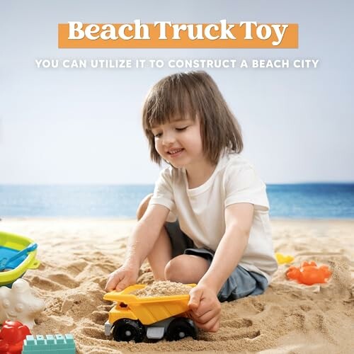 Child playing with a toy truck on the beach.