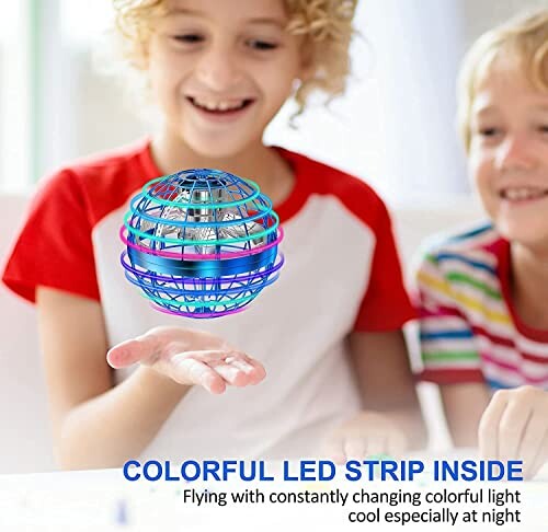 Children playing with a colorful LED flying orb toy.