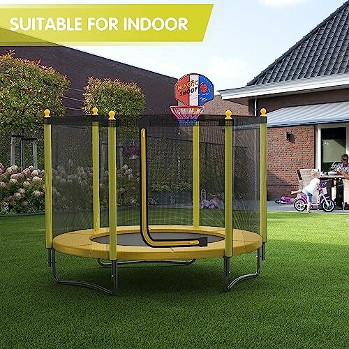 Trampoline with basketball hoop in a backyard garden.