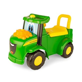 Green toy tractor with cartoon face