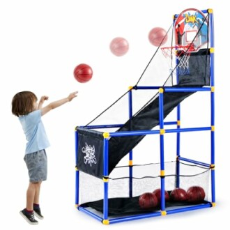 Child playing indoor basketball game with balls and hoop.
