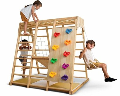 Children playing on a wooden indoor playset with climbing features and a swing.