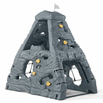 Children's climbing rock playset with yellow handholds.