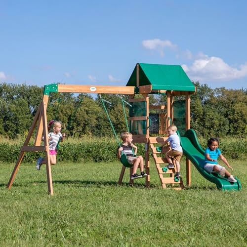 Children playing on a wooden outdoor playset with swings and a slide.