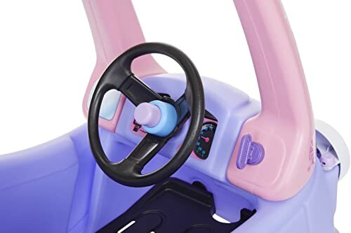 Interior of a purple and pink toy car with a steering wheel and dashboard.