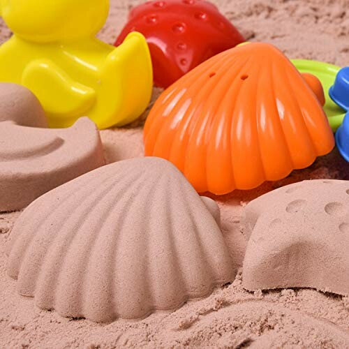 Colorful sandbox toys and molds on sand