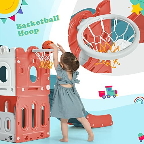 Toddler playing with a basketball hoop playset indoors.