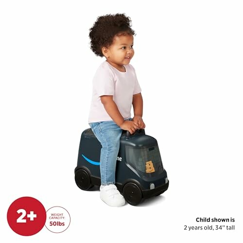 Toddler riding a toy truck designed like a delivery vehicle.