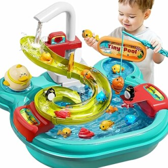 Toddler playing with a colorful water playset featuring slides and toy fish.