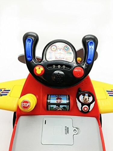 Toy car dashboard with colorful buttons and steering wheel